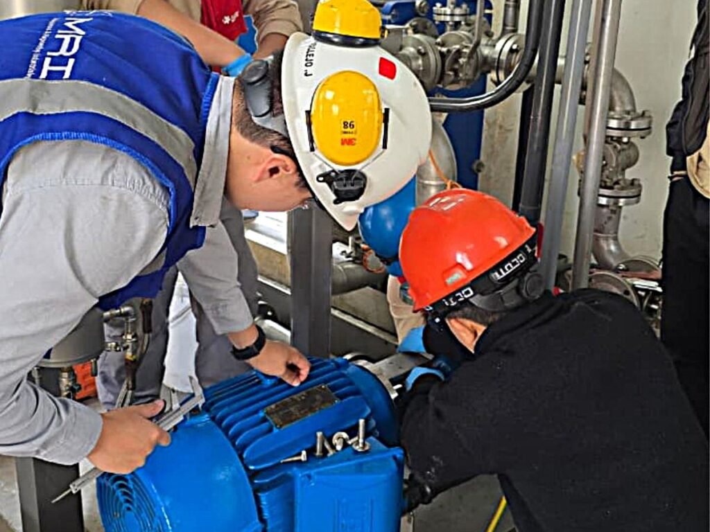 Equipo técnico de MRI realizando revisión de planes de mantenimiento industrial